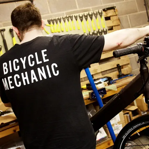 bicycle mechanic working on a bike
