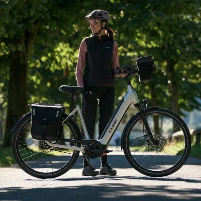a lady standing aside an electric bike