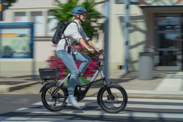 a cyclist commuting to work on an electric bike