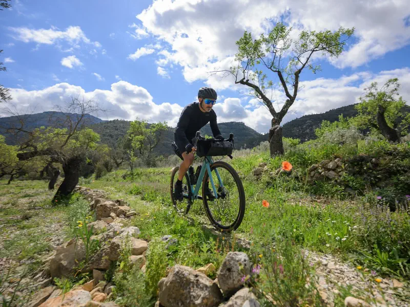a cyclist riding a gravel bike offroad
